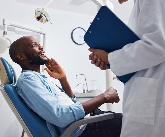 Male patient talking to a dentist