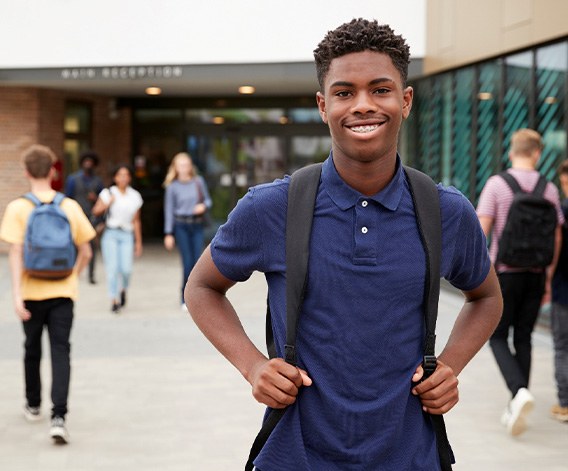 Teen smiling after returning to school after receiving nitrous oxide sedation