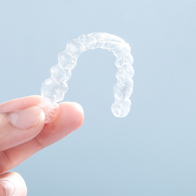 Patient holding clear aligner