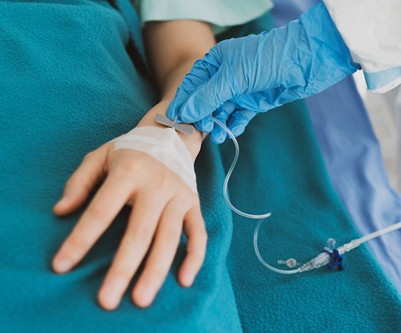 Patient with an IV in their hand
