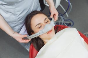 Woman receiving nitrous oxide sedation at dentist's office.